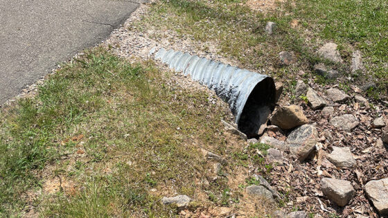 A drainage easement running under a driveway on a residential property.